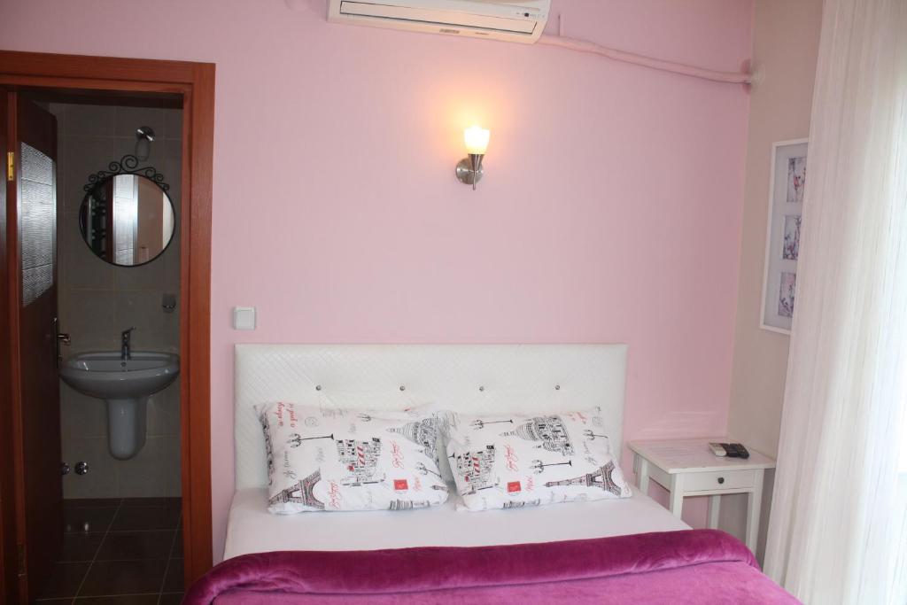 A bed or beds in a room at Sapphire Hotel
