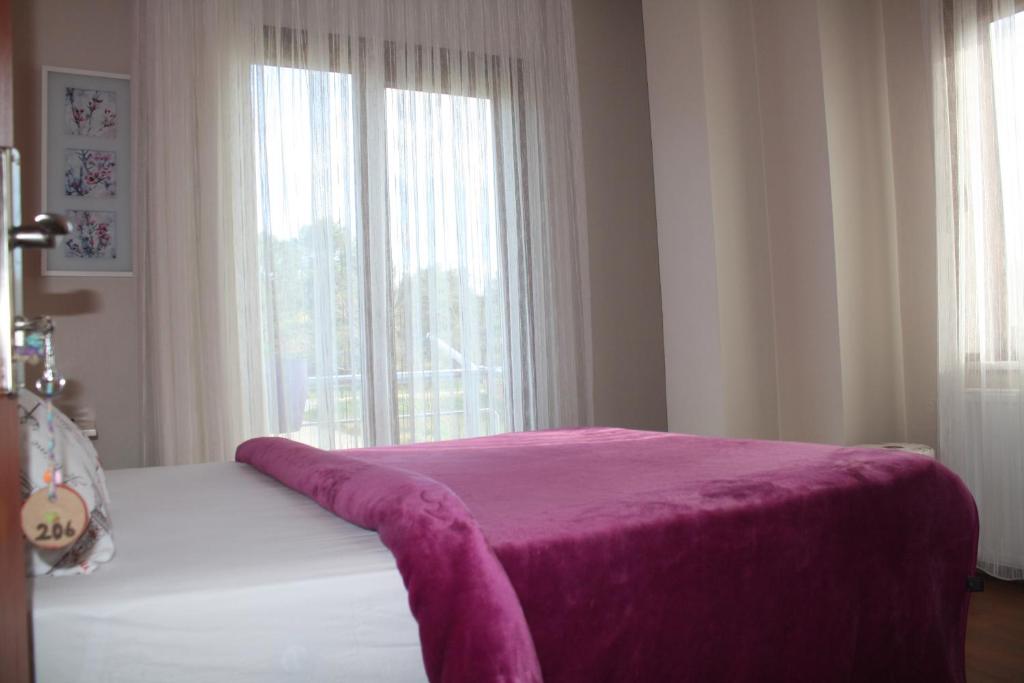 A bed or beds in a room at Sapphire Hotel