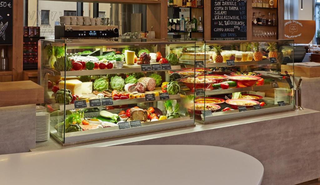 a display case filled with lots of fruits and vegetables at Novotel München City Arnulfpark in Munich