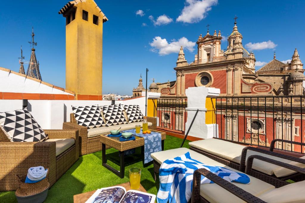 a rooftop patio with a view of a church at AlohaMundi Salvador in Seville