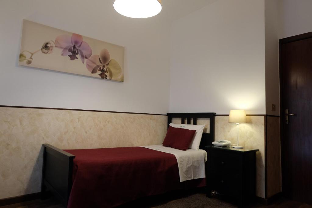 Postel nebo postele na pokoji v ubytování Hotel Villa Nettuno
