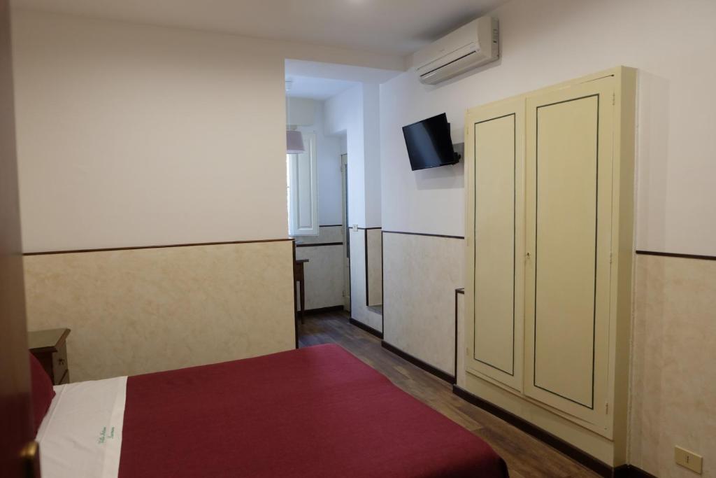 Postel nebo postele na pokoji v ubytování Hotel Villa Nettuno