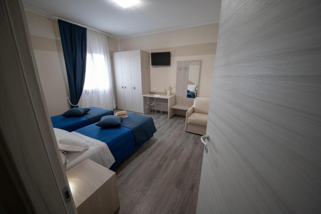 Postel nebo postele na pokoji v ubytování HOME HOTEL