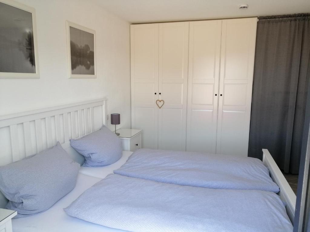 a bedroom with a bed with blue pillows at Ferienwohnung Selina-Sophie in Sehringen