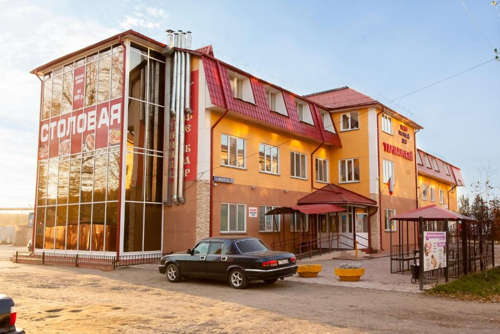 a car parked in front of a building at Tarmansky Hotel in Tyumen