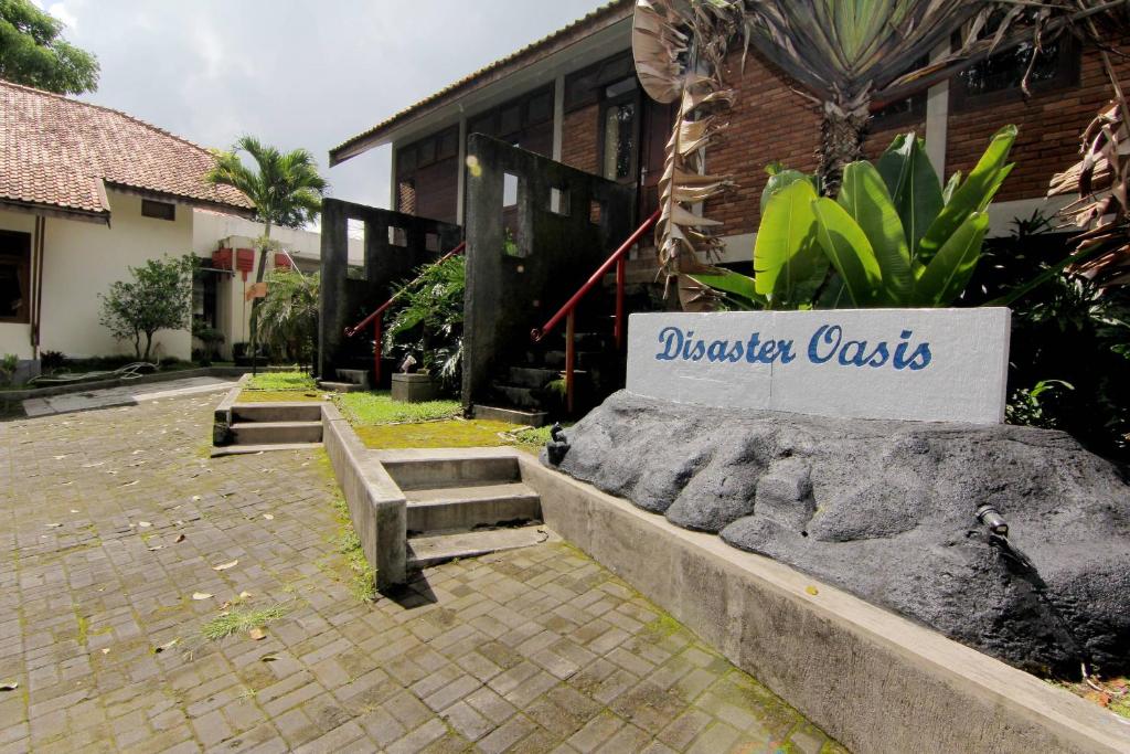 a building with a sign that reads disaster casias at Disaster Oasis in Kaliurang