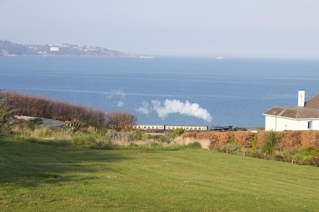 a train is on a track near the water at The Stoep in Paignton
