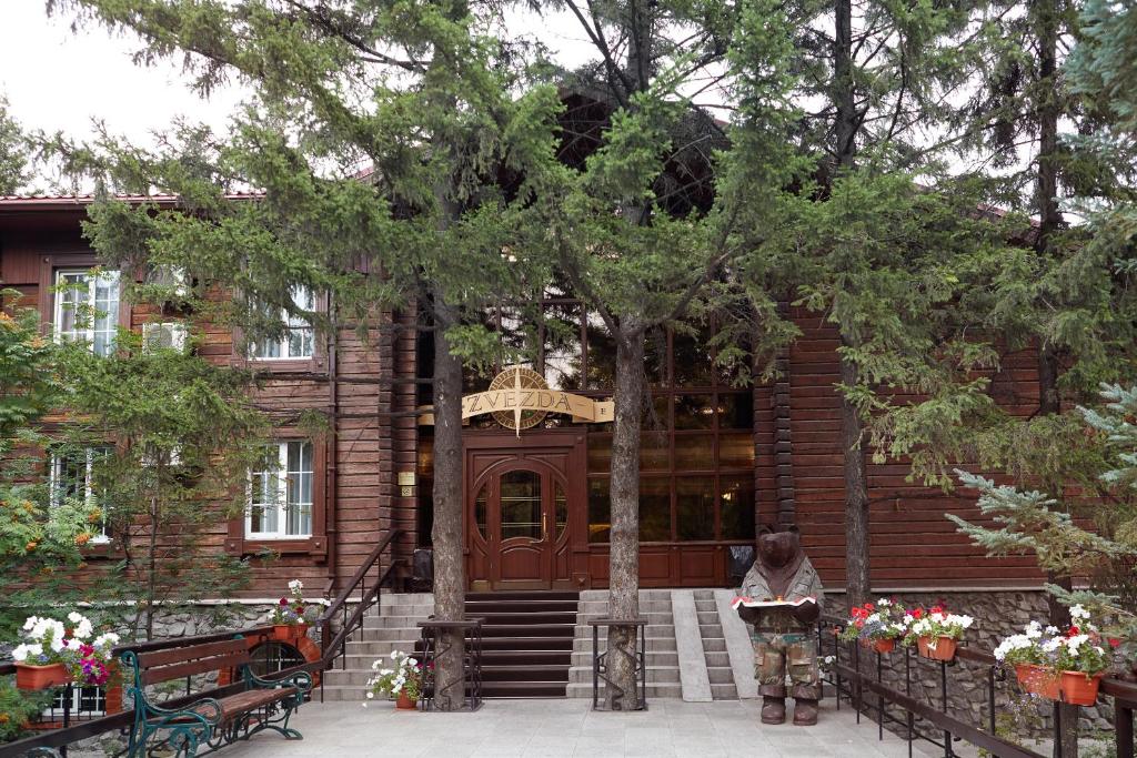 a man standing in front of a house at Zvezda Hotel in Irkutsk