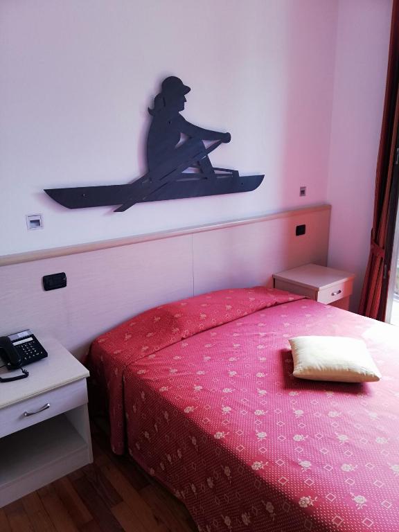 Een bed of bedden in een kamer bij Hotel Fioroni