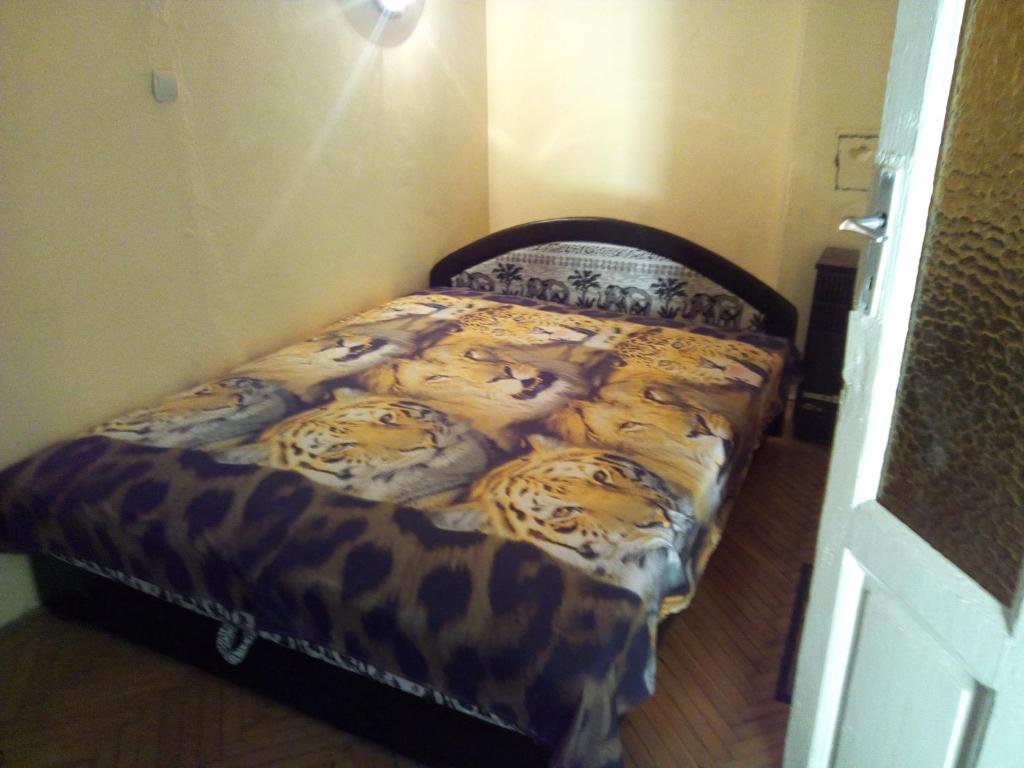 a bedroom with a bed with leopard at Operahouse Rooms in Budapest