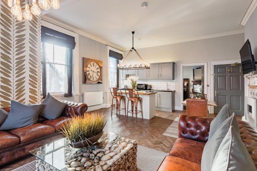 a living room with a couch and a table at The Thoresby at Claremont Serviced Apartments in Leeds