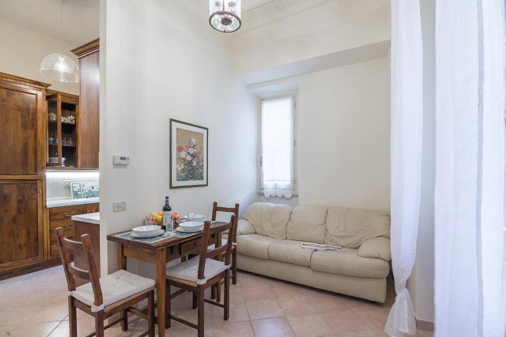 a living room with a table and a couch at Pontormo by Mmega in Florence