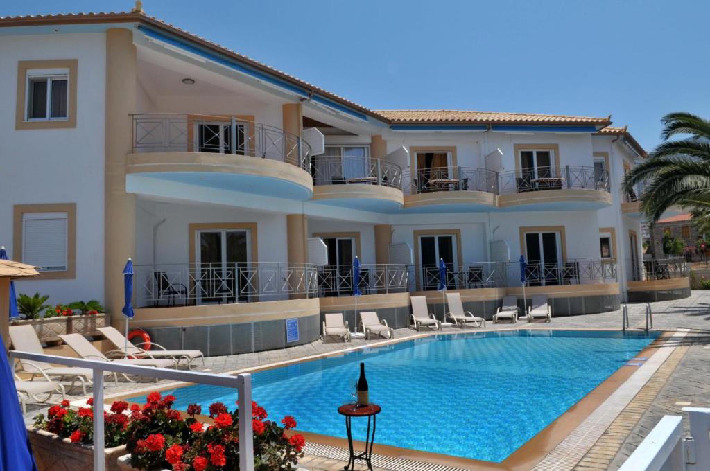 a hotel with a swimming pool in front of a building at Kasimis in Kyparissia