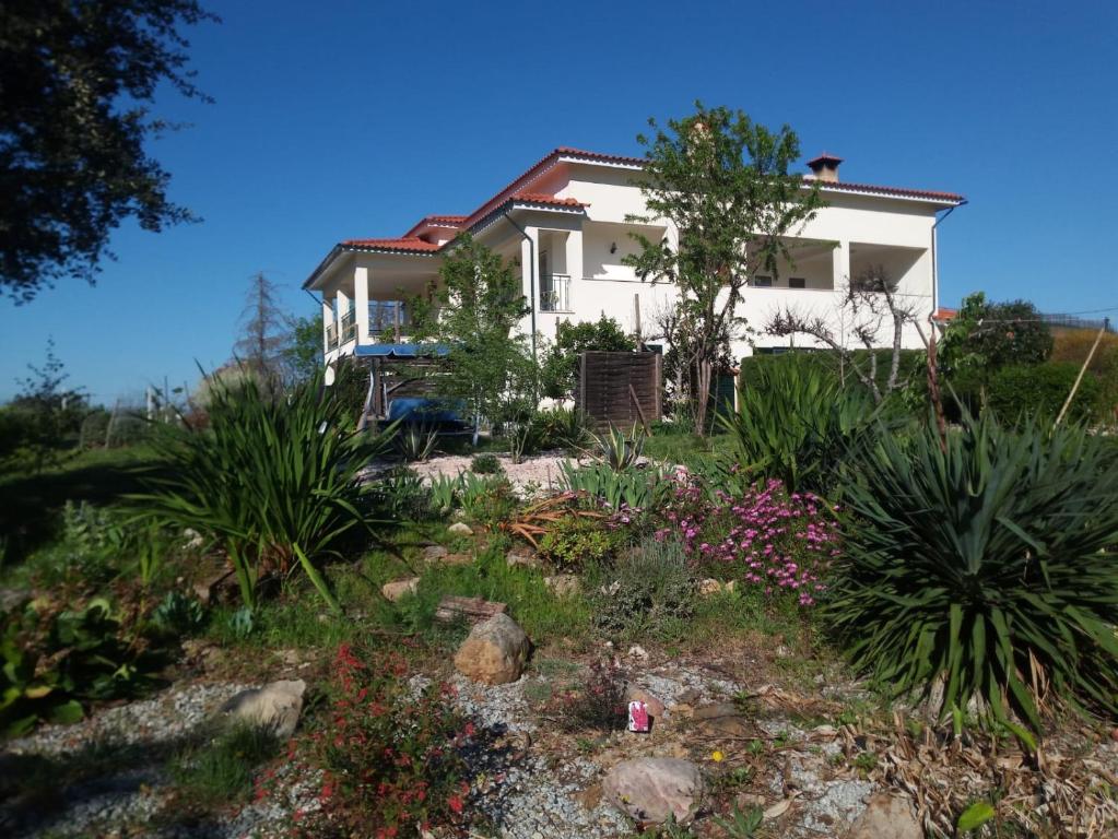 a house with a garden in front of it at Casa Gaia in Serpins