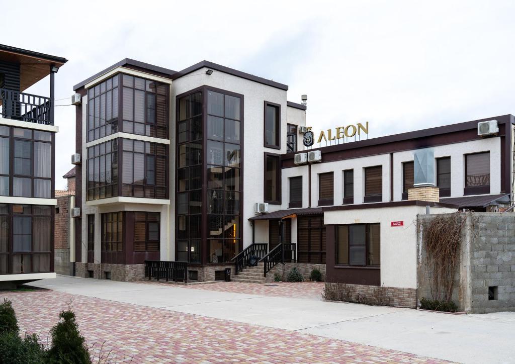 a building with a sign that reads albury at ALEON HOTEL in Makhachkala