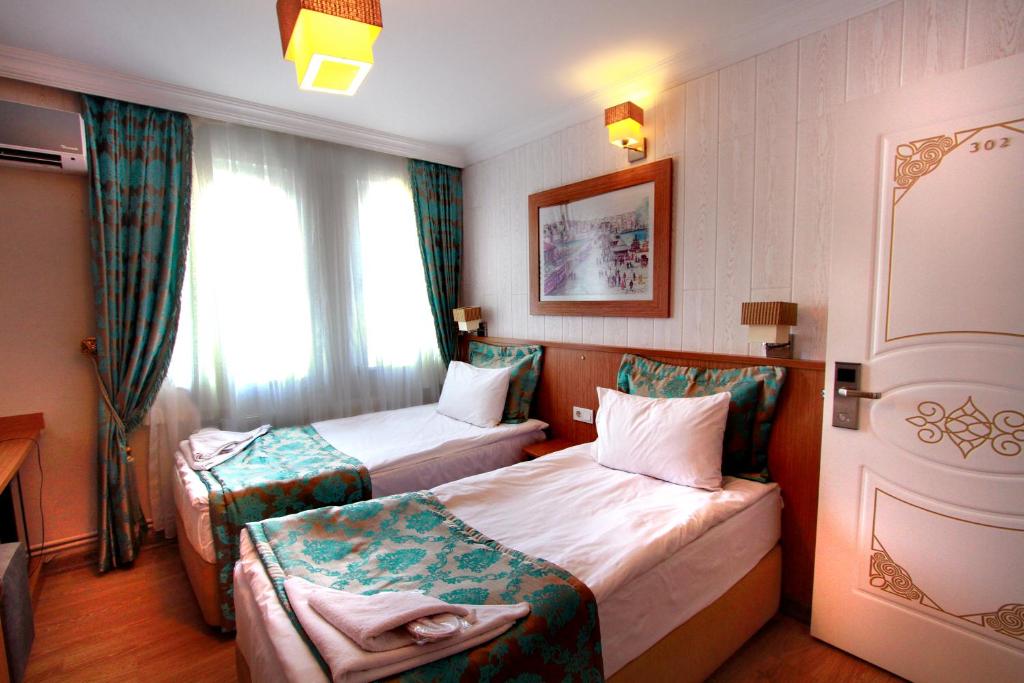 A bed or beds in a room at Agora Boutique Hotel & Bistro