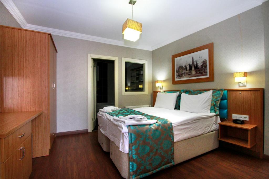 A bed or beds in a room at Agora Boutique Hotel & Bistro