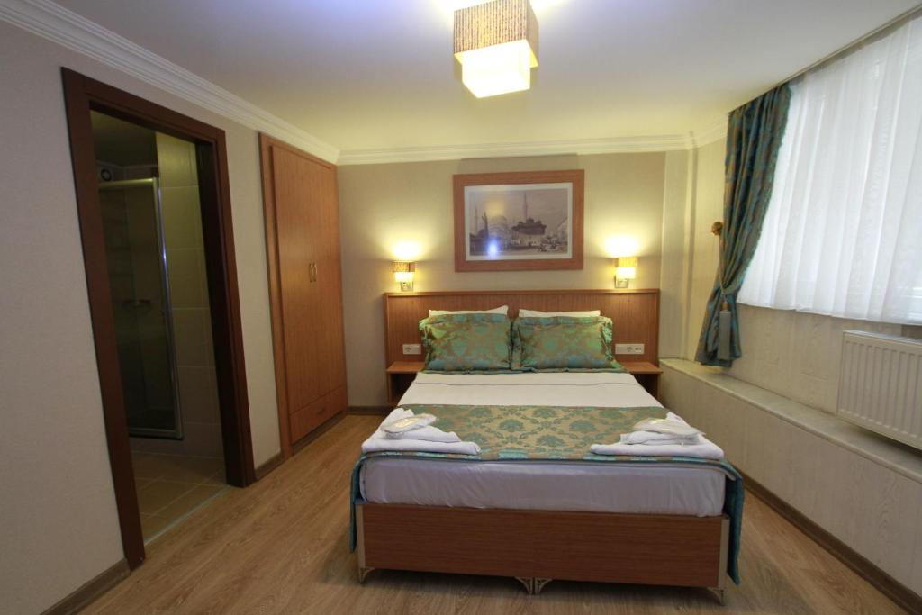 A bed or beds in a room at Agora Boutique Hotel & Bistro