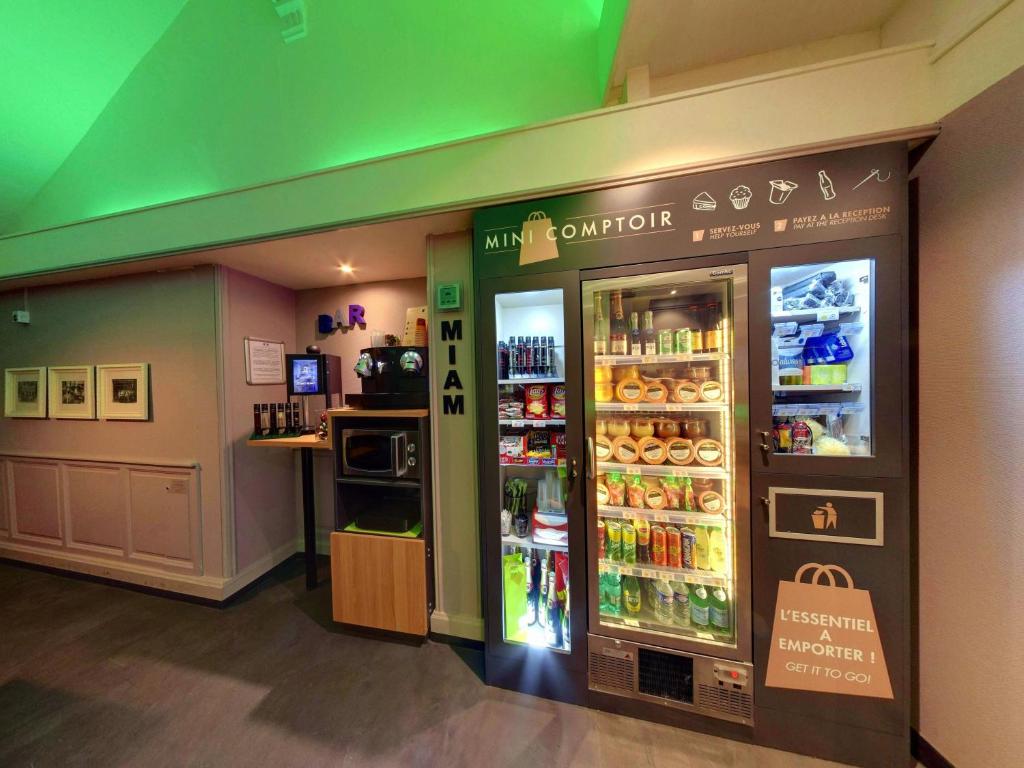 a store with a refrigerator with drinks in it at Campanile Orléans Centre Gare in Orléans