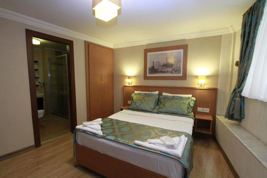 A bed or beds in a room at Agora Boutique Hotel & Bistro