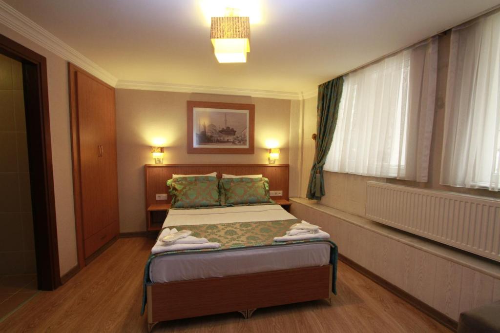 A bed or beds in a room at Agora Boutique Hotel & Bistro