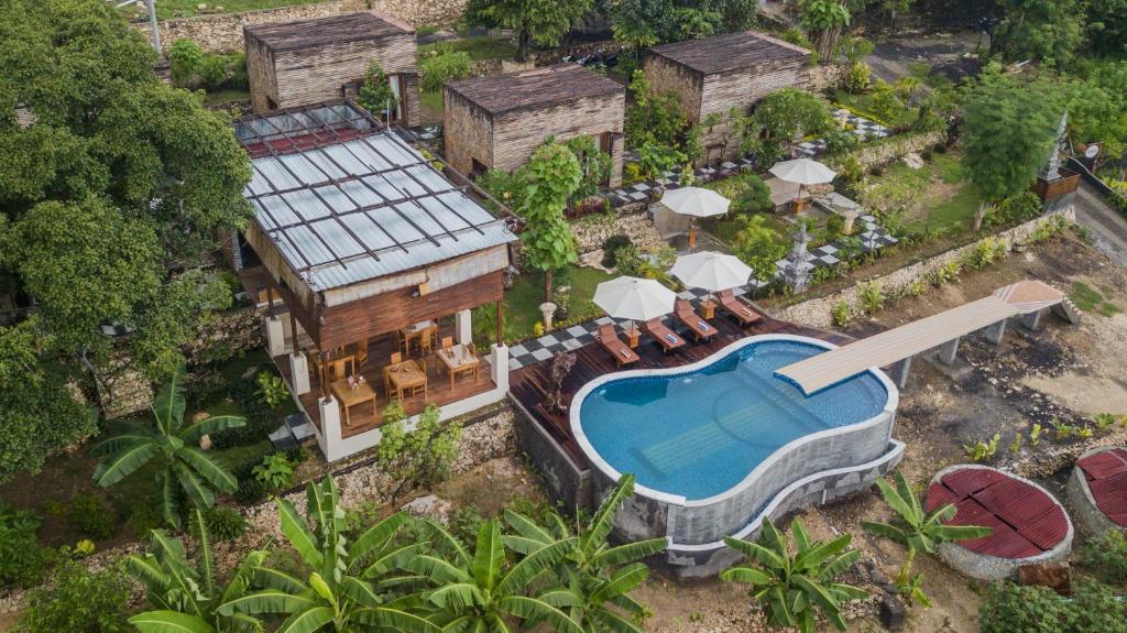 an aerial view of a house with a swimming pool at Kabeh Jati Garden Villa & Restaurant in Nusa Penida