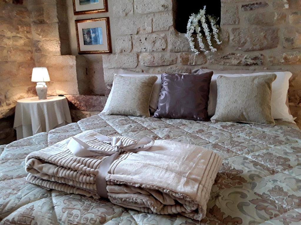 a bed with pillows and a blanket on it at Case Brizi 10 in Assisi