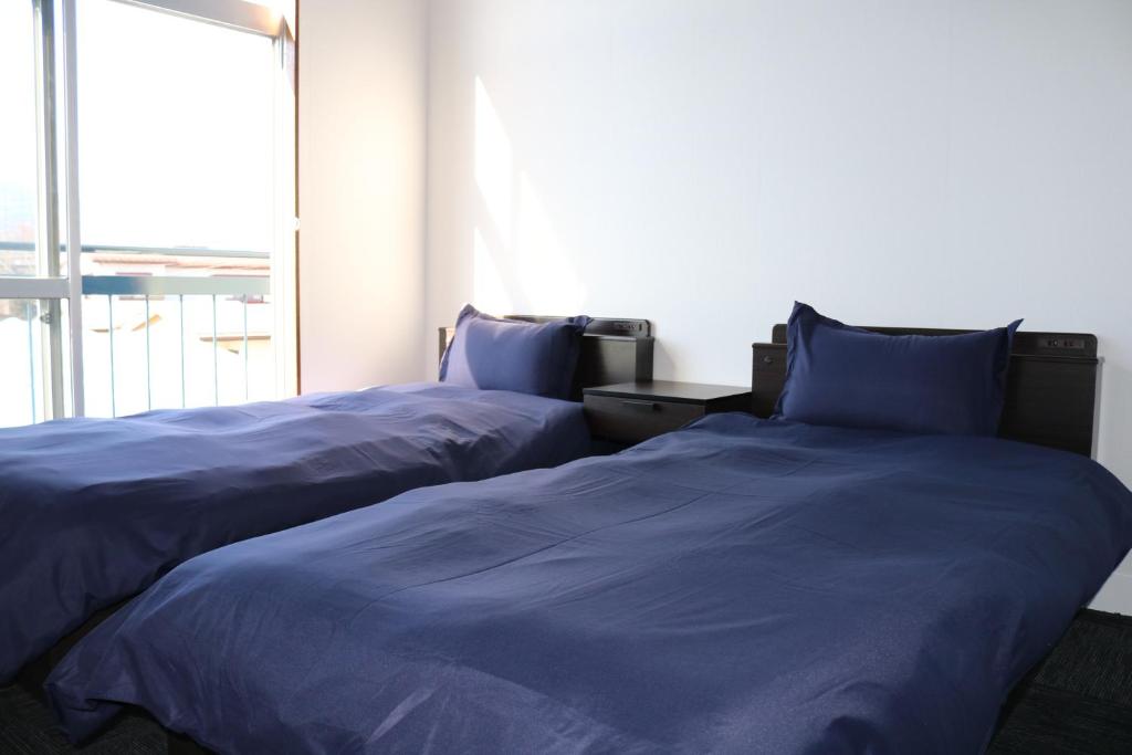 Postel nebo postele na pokoji v ubytování Fuji Guest House Ao