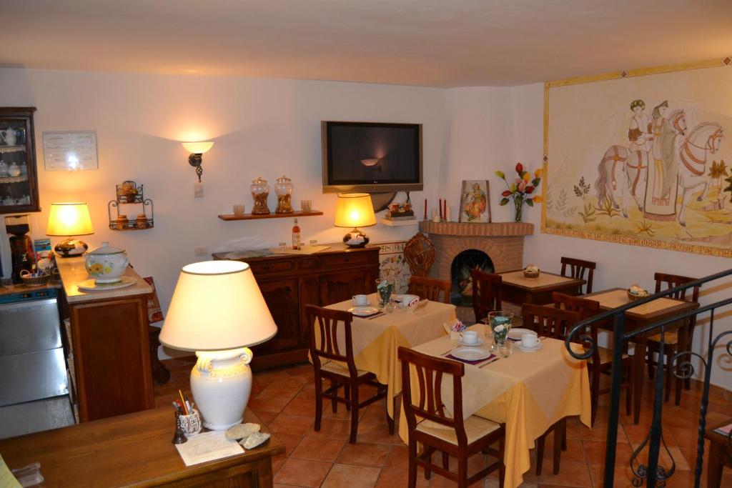 a dining room with two tables and a fireplace at Il Cantuccio in Poggio Murella