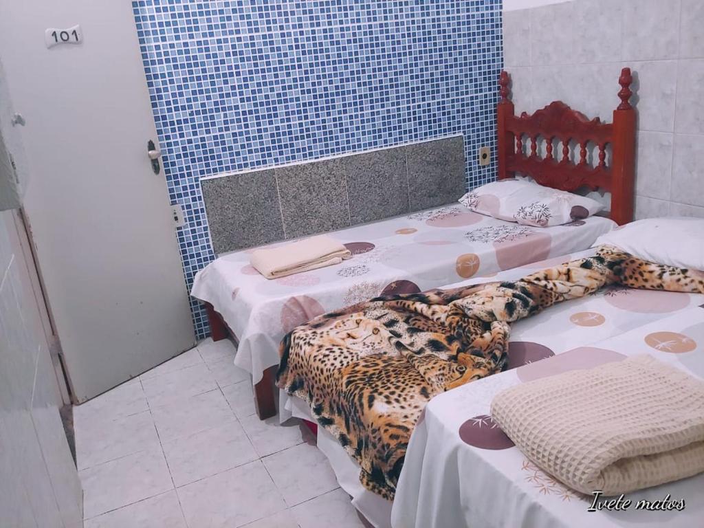 Un pat sau paturi într-o cameră la Pousada Refúgio