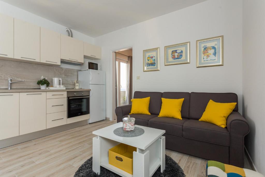 a living room with a couch and a table at Apartments Maximus in Dubrovnik