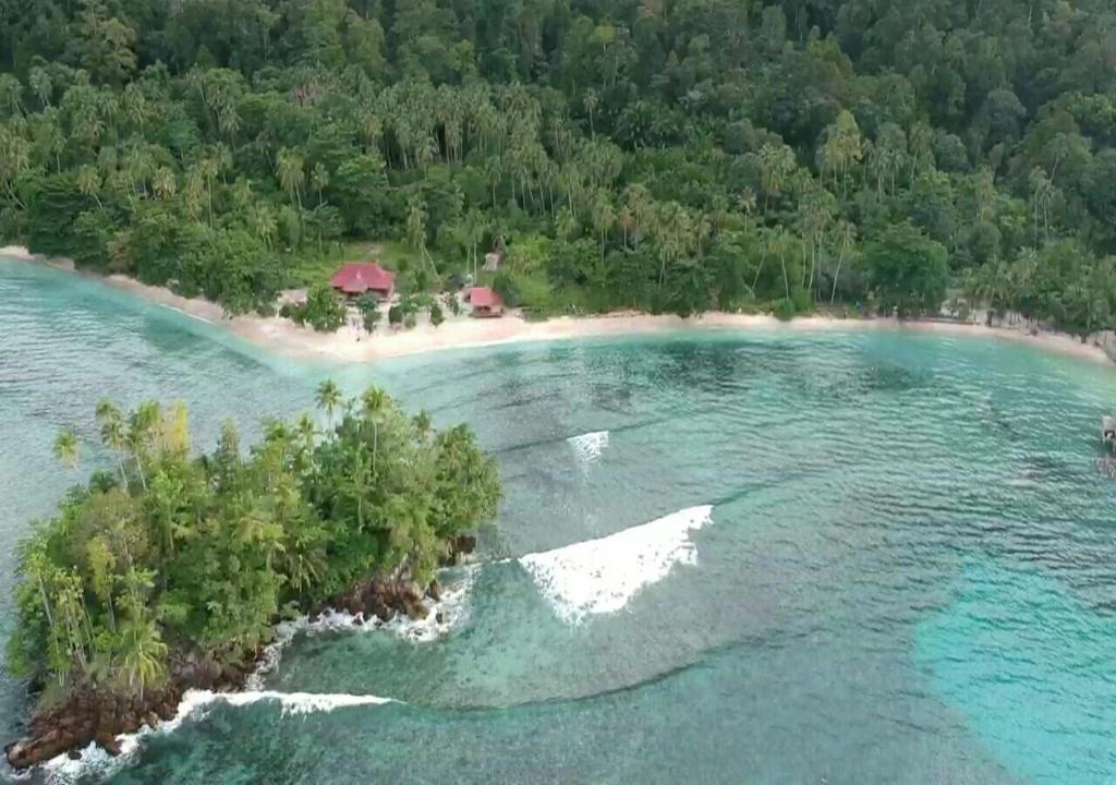 an aerial view of an island in the water at Nusa Nalan Beach Resort in Rumah Olat