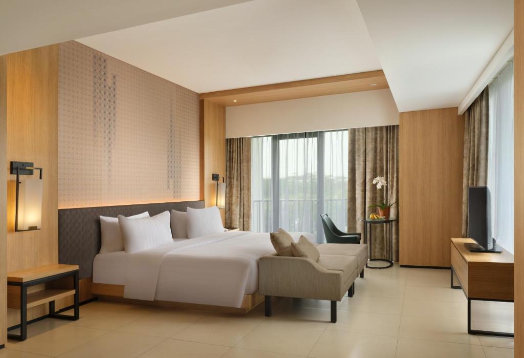 Postel nebo postele na pokoji v ubytování Hotel Santika Premiere Bandara Palembang