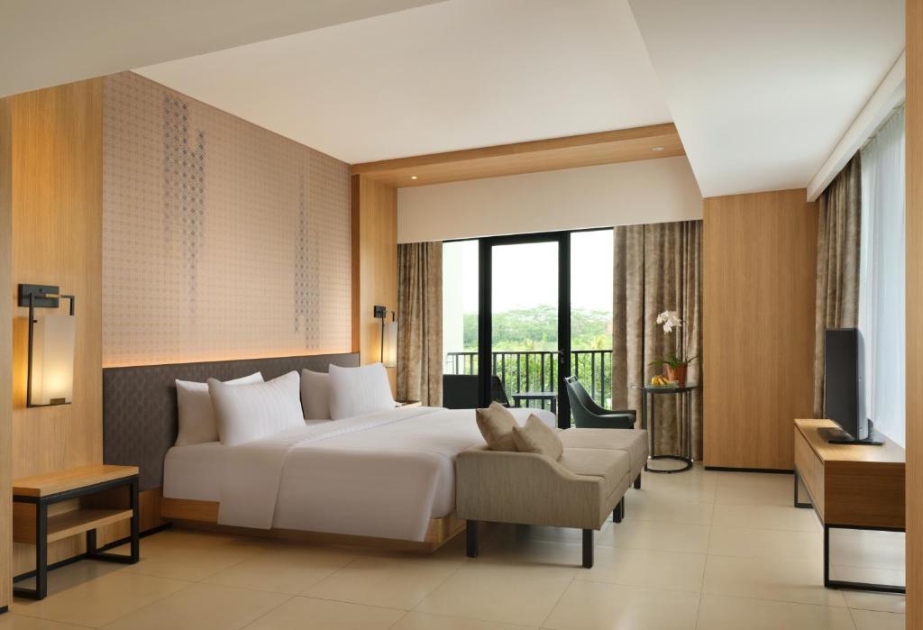Postel nebo postele na pokoji v ubytování Hotel Santika Premiere Bandara Palembang