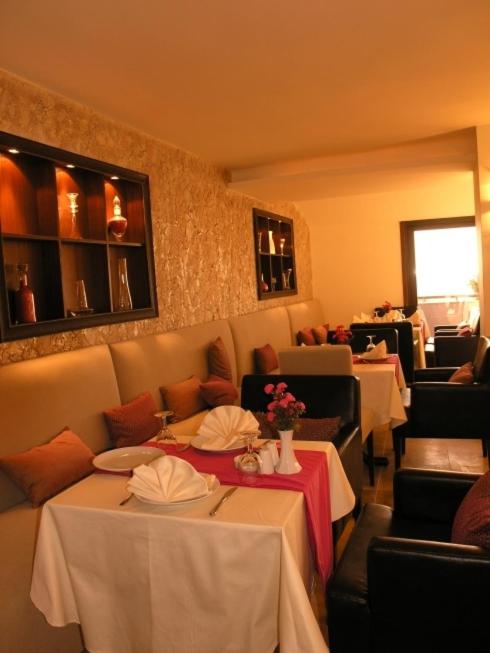 a dining room with two tables and chairs at Silivri Park Hotel in Silivri
