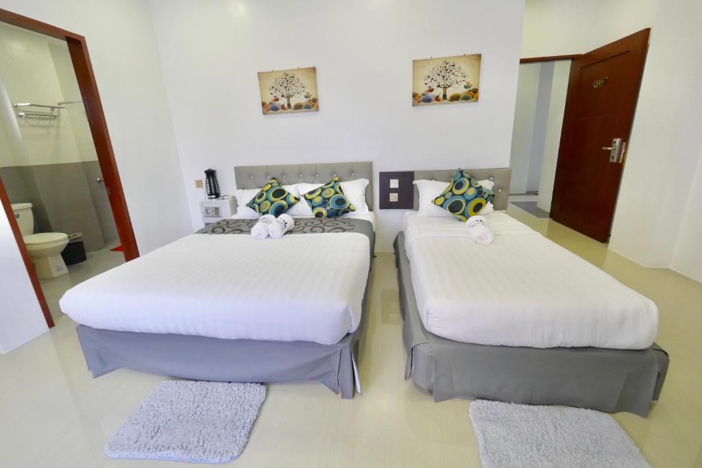Postel nebo postele na pokoji v ubytování Mirage Suites de Boracay