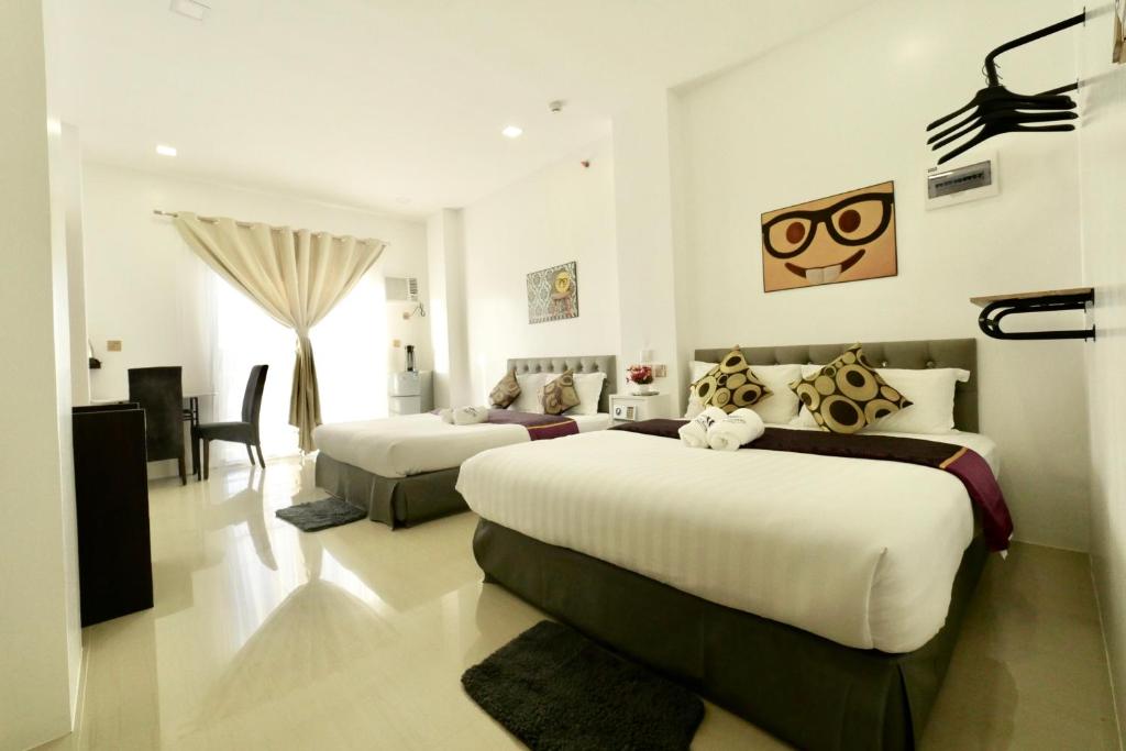 Postel nebo postele na pokoji v ubytování Mirage Suites de Boracay