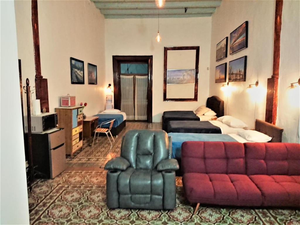 a living room with a bed and a couch at Suite Vintage in Puebla