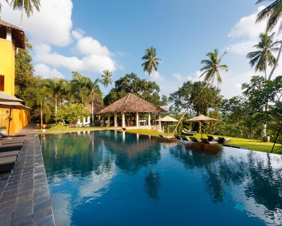 a swimming pool in front of a resort at Kahanda Kanda in Koggala