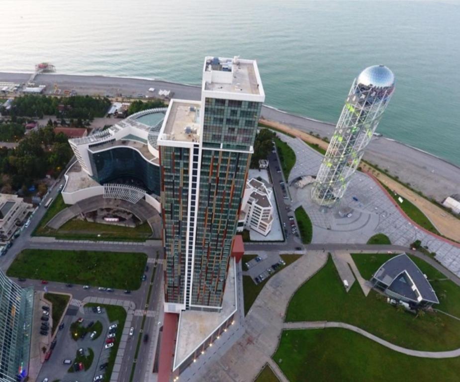 an aerial view of a building and a tower at Premium apartment in Porta Batumi Tower in Batumi