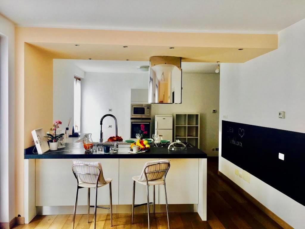 a kitchen with two bar stools and a counter at CASA MADDALENA in Lierna