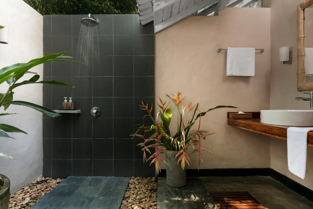 a bathroom with a shower and a sink at Kahanda Kanda in Koggala