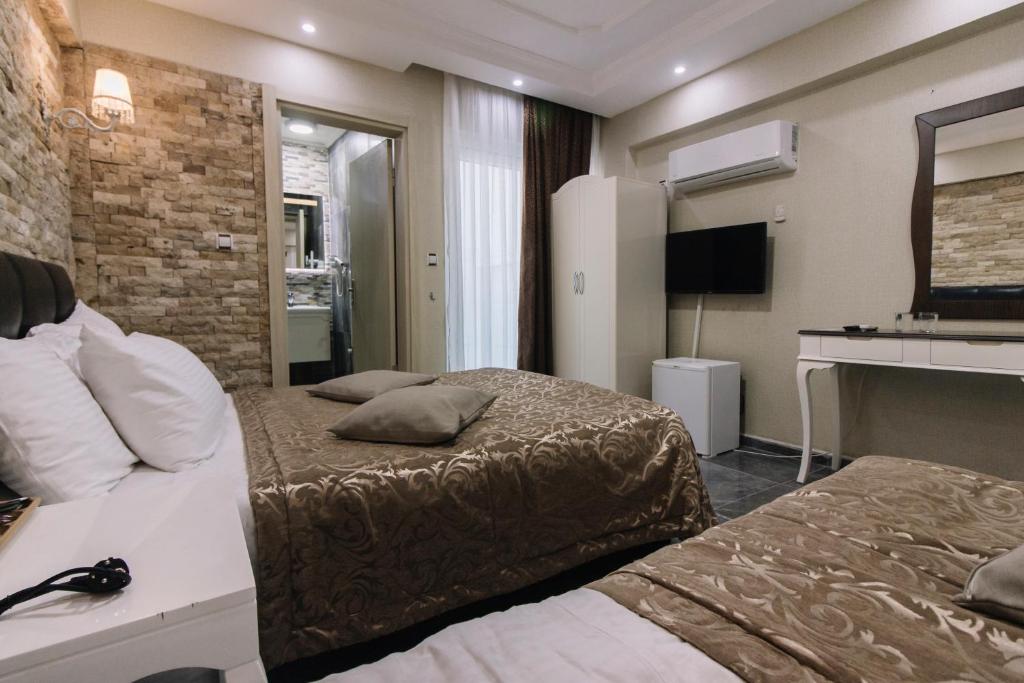 TV a/nebo společenská místnost v ubytování Melrose House Hotel
