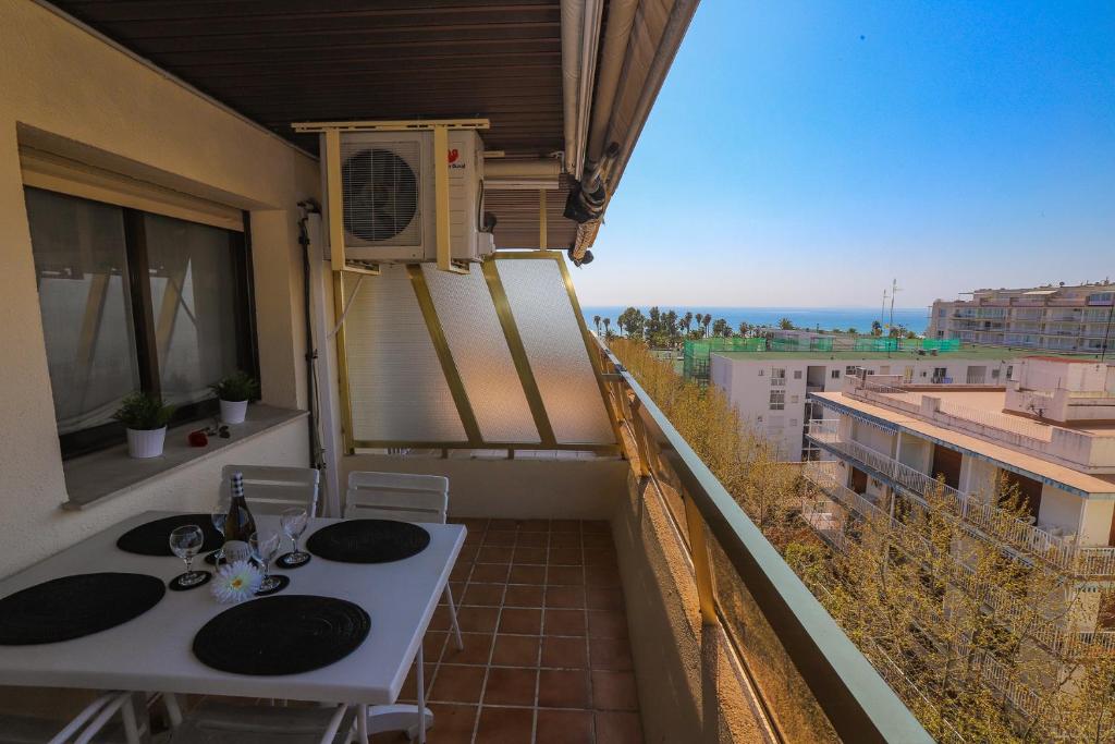 a balcony with a table and a view of the ocean at COSTA DAURADA APARTAMENTS - Zurbaran in Salou
