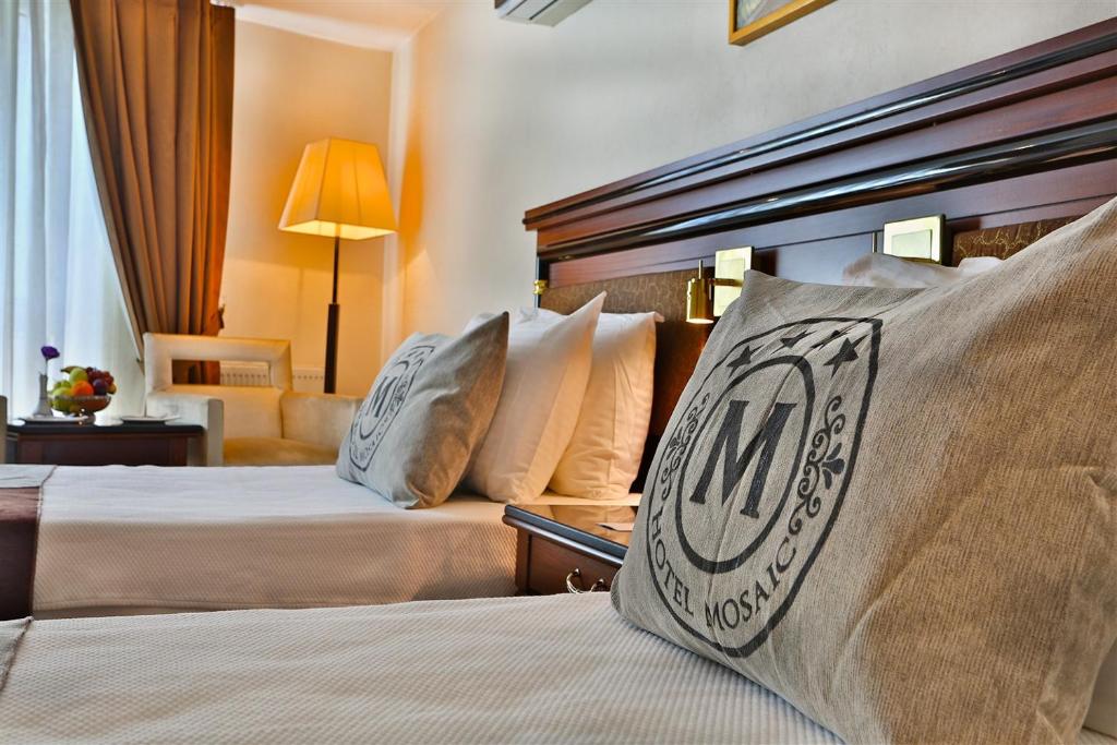 a hotel room with two beds and a couch at Mosaic Hotel Old City -Special Category in Istanbul
