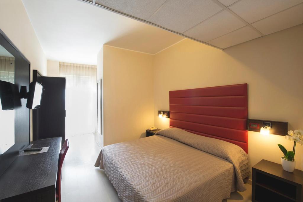 Postel nebo postele na pokoji v ubytování Grand Hotel Adriatico
