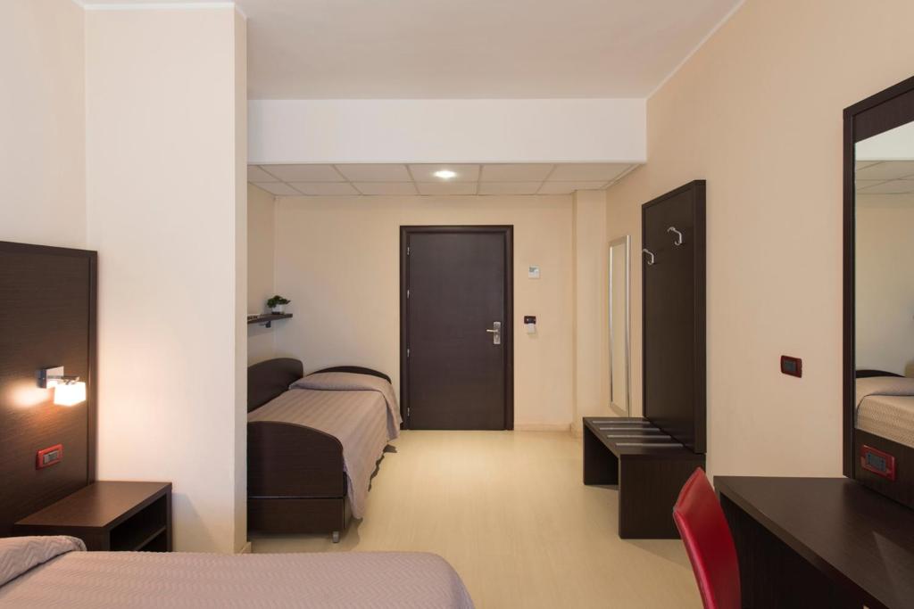 Postel nebo postele na pokoji v ubytování Grand Hotel Adriatico