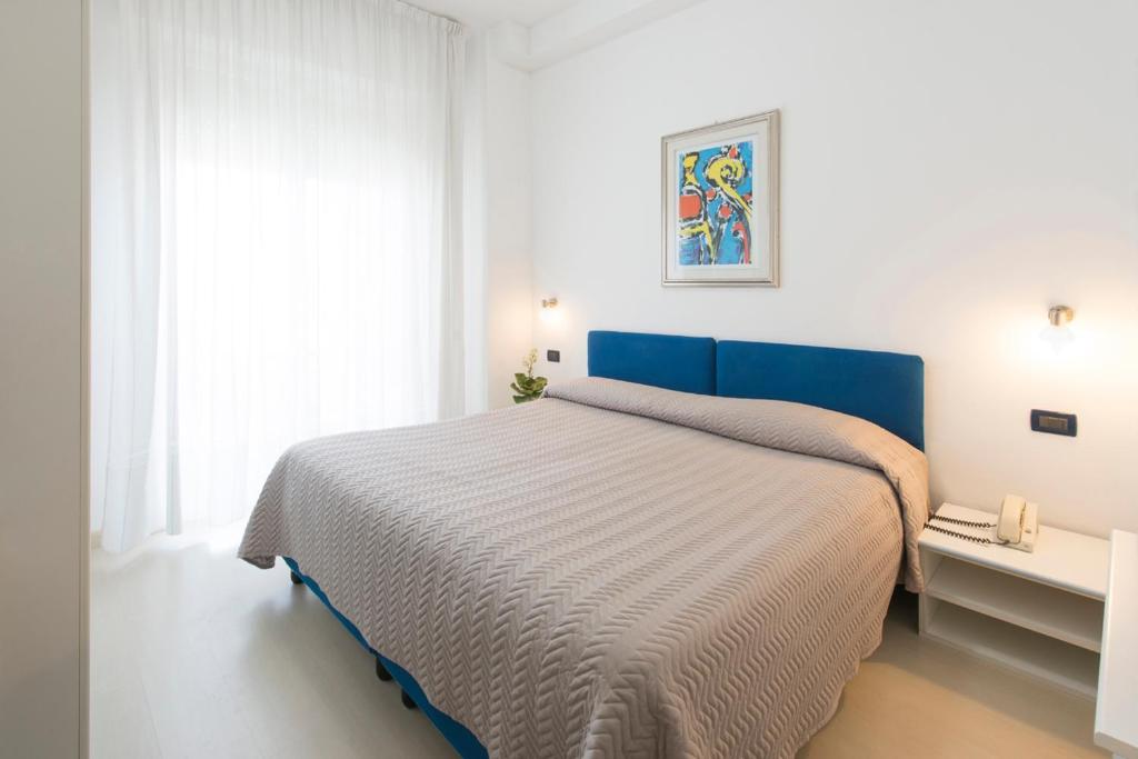 Postel nebo postele na pokoji v ubytování Grand Hotel Adriatico