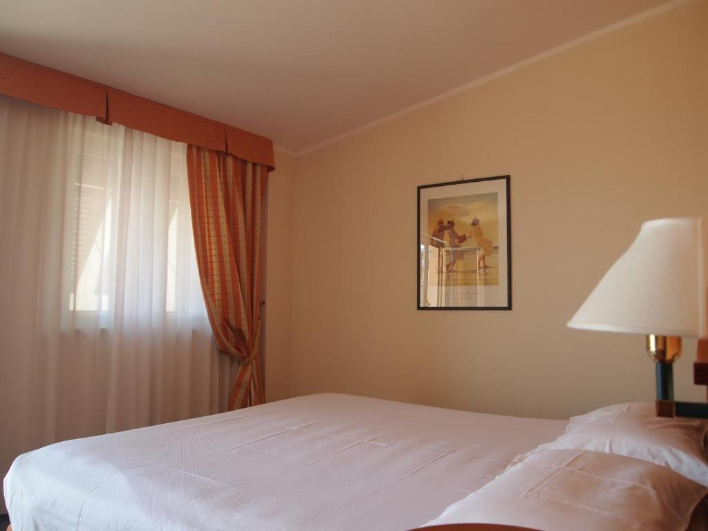 Postel nebo postele na pokoji v ubytování Piccolo Hotel
