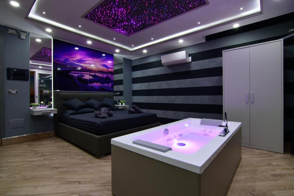 a bathroom with a couch and a bath tub in a room at Starry Sky Charming House in Alghero